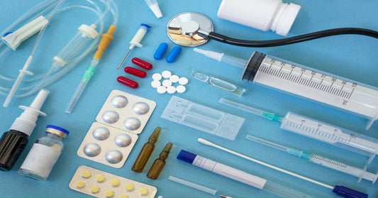 An array of different medical supplies, including syringes, pills, and tinctures, against a blue background.